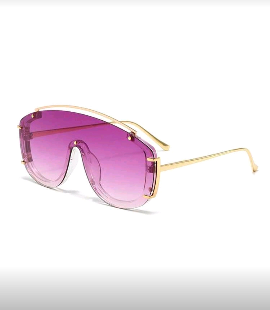 Sunglasses with gold frame and purple lenses on a white background