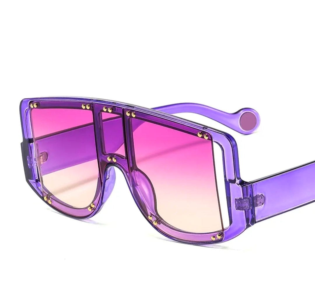 Sunglasses with purple frame and pink gradient lenses on a white background